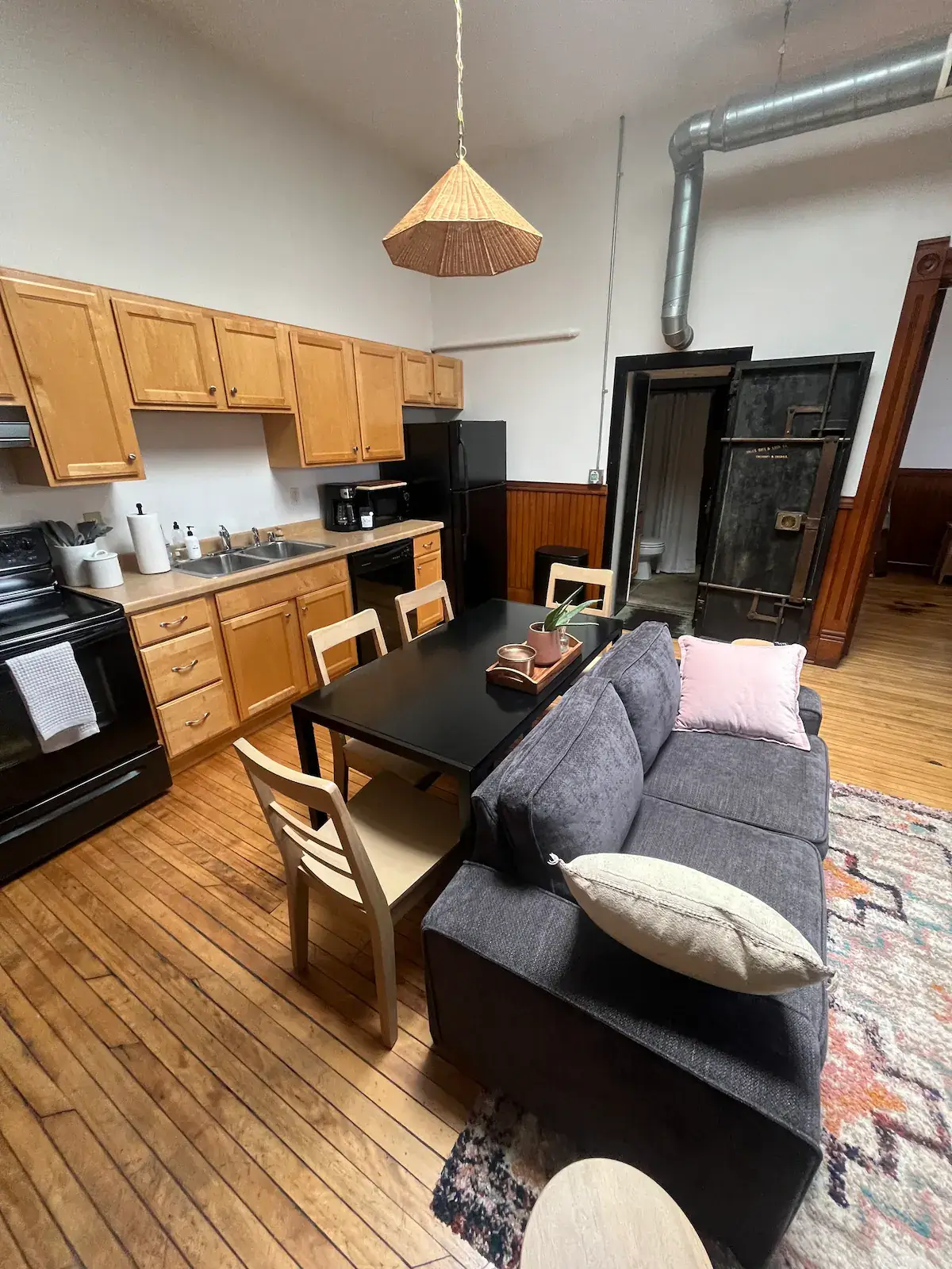 a living room with a couch a table and a stove